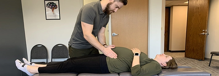 Chiropractic Edina MN Doctor Adjusting Pregnant Mother